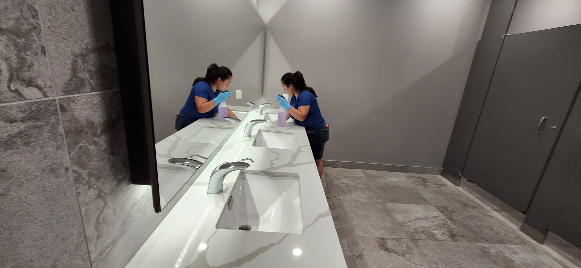 Yesica cleaning a commercial bathroom in Hamilton